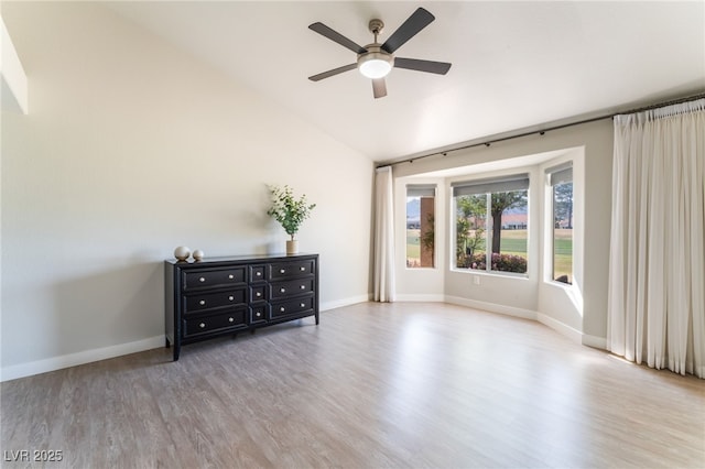 2725 Showcase Dr, Las Vegas, NV 89134 - spare room with wood finished floors, ceiling fan, baseboards, and vaulted ceiling