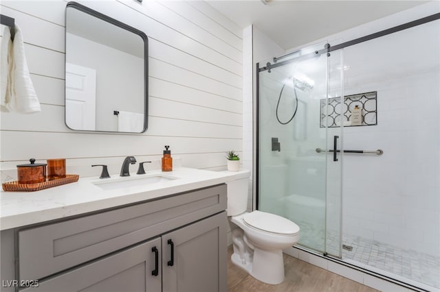 2725 Showcase Dr, Las Vegas, NV 89134 - bathroom with toilet, a stall shower, wood finished floors, and vanity
