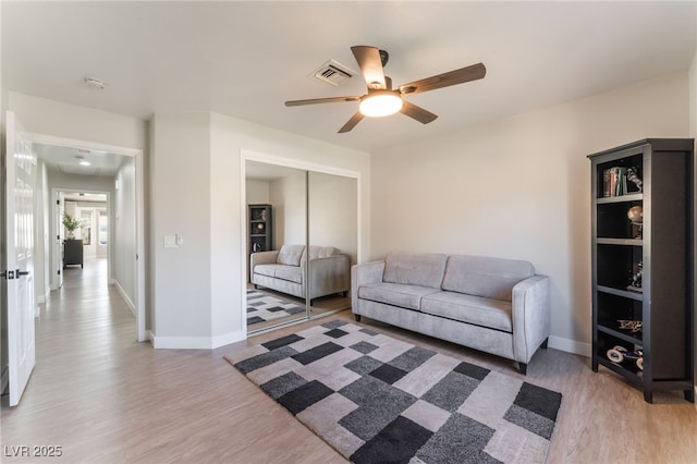 2725 Showcase Dr, Las Vegas, NV 89134 - living area with visible vents, ceiling fan, light wood-style floors, and baseboards