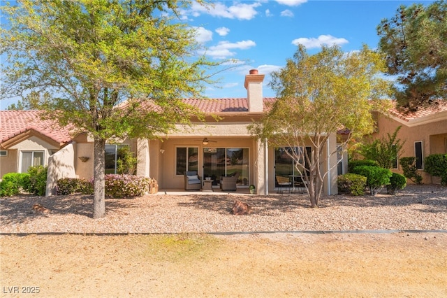 2725 Showcase Dr, Las Vegas, NV 89134 - rear view of property featuring a tiled roof, stucco siding, a patio area, and a chimney