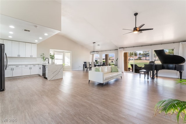 2725 Showcase Dr, Las Vegas, NV 89134 - living room featuring high vaulted ceiling, ceiling fan, visible vents, light wood finished floors, and baseboards