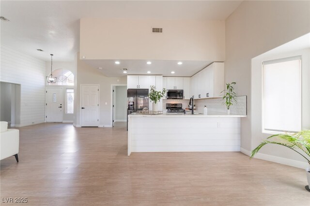 2725 Showcase Dr, Las Vegas, NV 89134 - kitchen featuring a peninsula, light countertops, visible vents, appliances with stainless steel finishes, and light wood finished floors