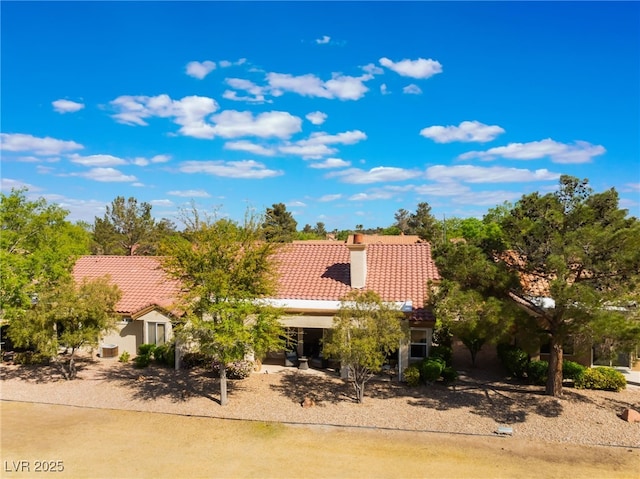 2725 Showcase Dr, Las Vegas, NV 89134 - mediterranean / spanish house featuring stucco siding, a tiled roof, and a chimney