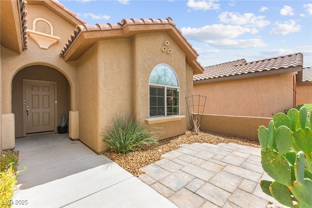 3528 Tack St, Las Vegas, NV 89122 - entrance to property featuring a patio, a tiled roof, and stucco siding