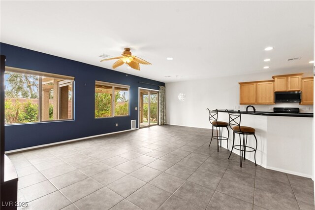 3528 Tack St, Las Vegas, NV 89122 - kitchen with recessed lighting, light tile patterned floors, dark countertops, visible vents, and ceiling fan