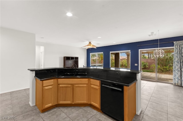 3528 Tack St, Las Vegas, NV 89122 - kitchen with black dishwasher, a kitchen island with sink, a sink, and plenty of natural light