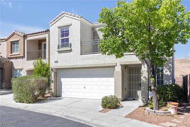 view of property with concrete driveway, stucco siding, and an attached garage