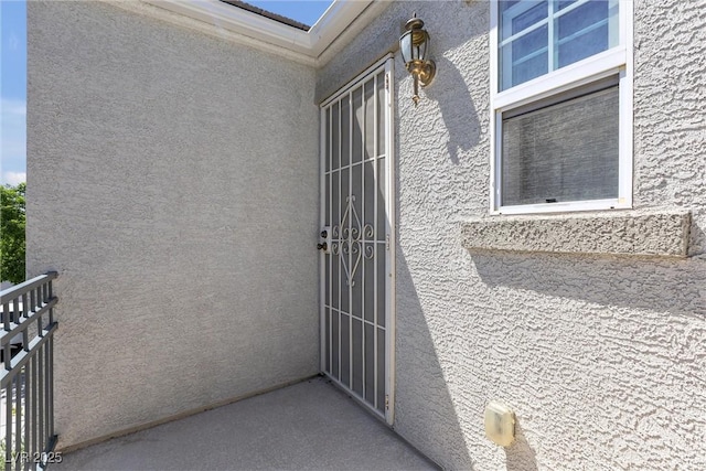 entrance to property with stucco siding
