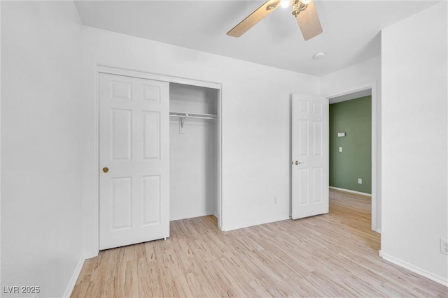 unfurnished bedroom with a closet, light wood-style floors, and baseboards
