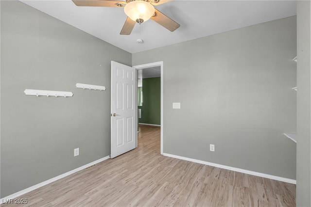 unfurnished room with ceiling fan, baseboards, and wood finished floors