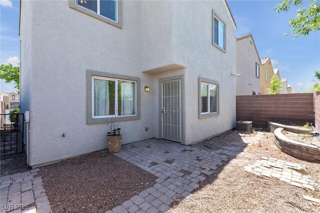 back of house featuring a patio, a fenced backyard, and stucco siding