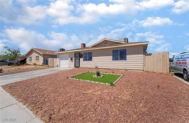 4786 San Rafael Ave, Las Vegas, NV 89120 - ranch-style home with an attached garage, a chimney, fence, and concrete driveway