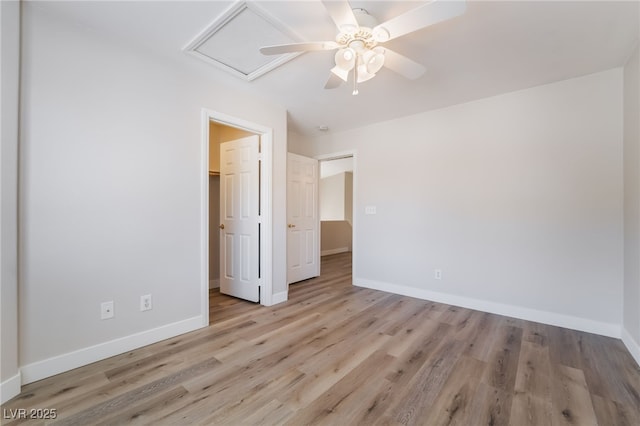 unfurnished bedroom with baseboards, wood finished floors, and a ceiling fan