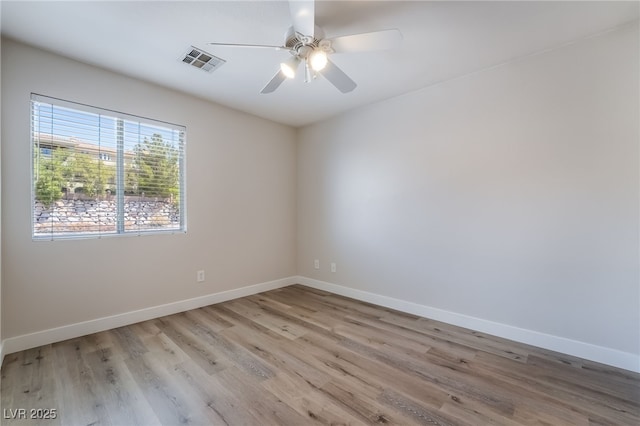 unfurnished room featuring wood finished floors, baseboards, and ceiling fan