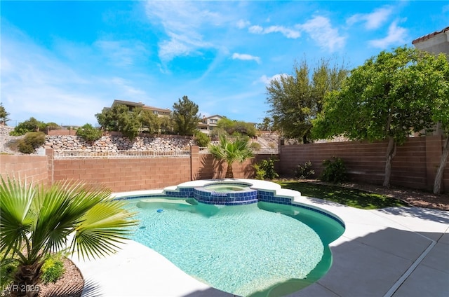 view of pool featuring a fenced backyard and a pool with connected hot tub