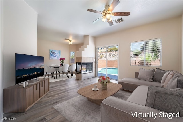 844 Binbrook Dr, Henderson, NV 89052 - living room featuring wood finished floors, a tile fireplace, and ceiling fan