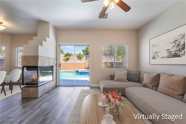 844 Binbrook Dr, Henderson, NV 89052 - living area featuring wood finished floors, plenty of natural light, a fireplace, and ceiling fan