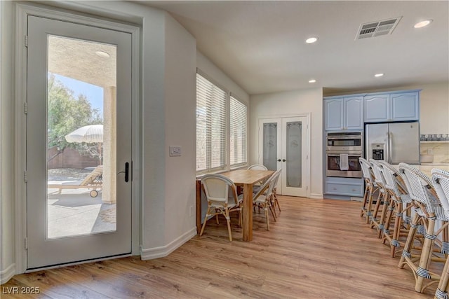 9992 Sky Parlor Rd, Las Vegas, NV 89178 - dining room with french doors, visible vents, a wealth of natural light, and light wood-style flooring