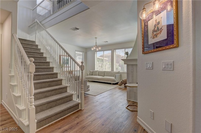 9992 Sky Parlor Rd, Las Vegas, NV 89178 - stairway featuring visible vents, baseboards, a chandelier, and wood finished floors
