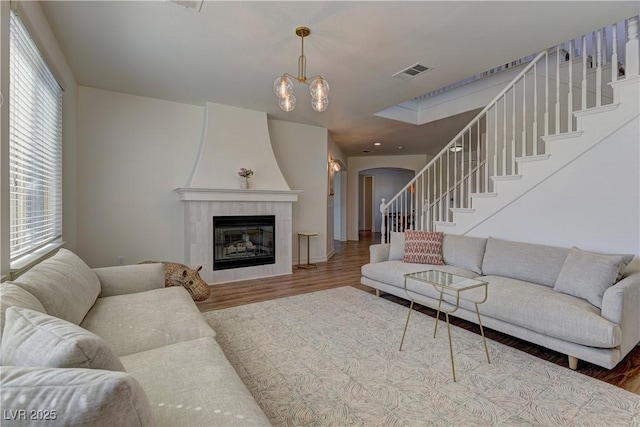 9992 Sky Parlor Rd, Las Vegas, NV 89178 - living area with arched walkways, visible vents, stairs, and wood finished floors