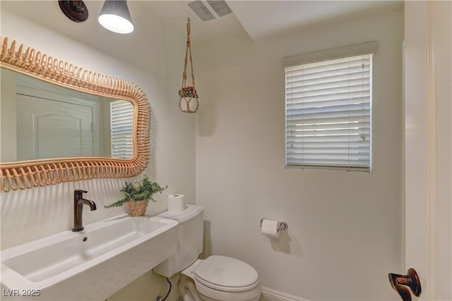 9992 Sky Parlor Rd, Las Vegas, NV 89178 - half bathroom with visible vents, baseboards, a sink, and toilet