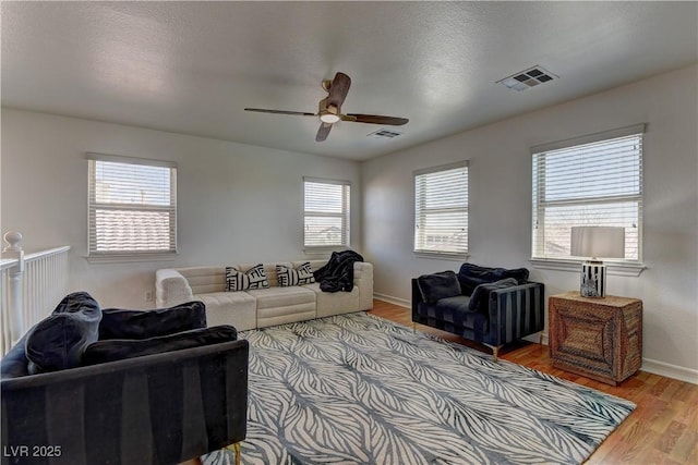 9992 Sky Parlor Rd, Las Vegas, NV 89178 - living room with visible vents, ceiling fan, baseboards, and wood finished floors