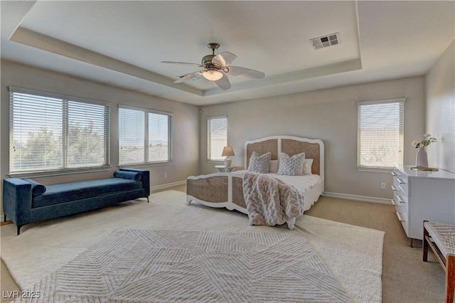 9992 Sky Parlor Rd, Las Vegas, NV 89178 - bedroom with ceiling fan, light colored carpet, visible vents, a raised ceiling, and baseboards