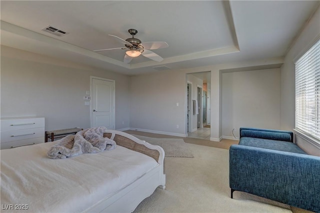 9992 Sky Parlor Rd, Las Vegas, NV 89178 - bedroom with baseboards, a ceiling fan, visible vents, a tray ceiling, and light colored carpet