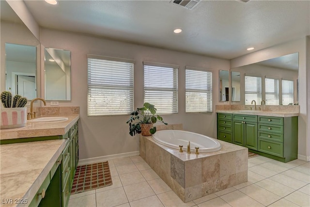 9992 Sky Parlor Rd, Las Vegas, NV 89178 - bathroom featuring a bath, visible vents, a sink, and two vanities