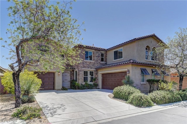 9992 Sky Parlor Rd, Las Vegas, NV 89178 - mediterranean / spanish home featuring stone siding, a garage, a tile roof, concrete driveway, and stucco siding