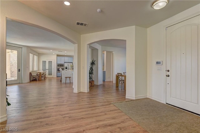 9992 Sky Parlor Rd, Las Vegas, NV 89178 - foyer entrance with light wood-style flooring, arched walkways, visible vents, recessed lighting, and baseboards