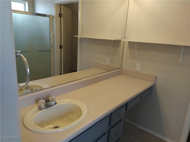 full bathroom featuring a shower with door, tile patterned flooring, and vanity