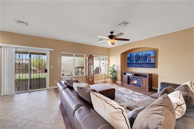 living area featuring baseboards, visible vents, and plenty of natural light
