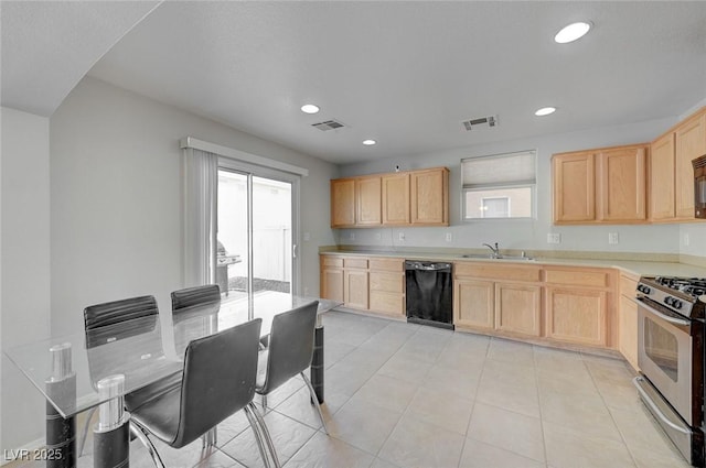 kitchen featuring black dishwasher, a sink, light brown cabinets, and stainless steel gas stove
