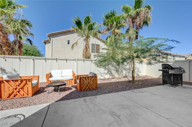 view of patio / terrace with a fenced backyard, a fire pit, and area for grilling