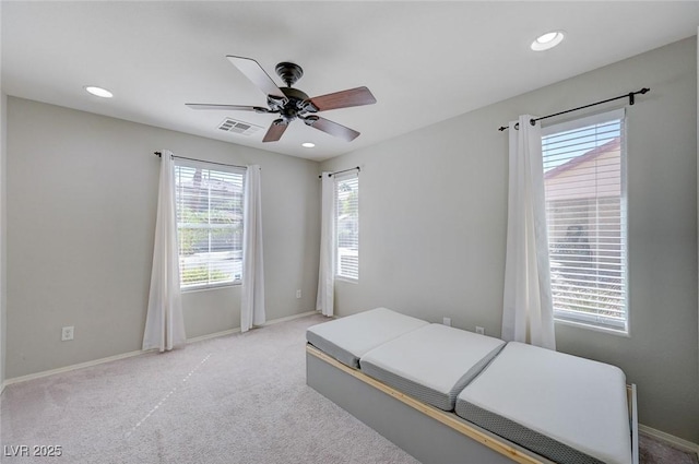 carpeted bedroom with visible vents, baseboards, and recessed lighting