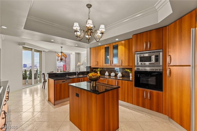 2877 Paradise Rd Unit 2502, Las Vegas, NV 89109 - kitchen featuring stainless steel appliances, a chandelier, brown cabinetry, a peninsula, and recessed lighting