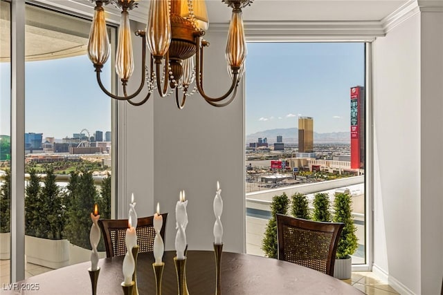 2877 Paradise Rd Unit 2502, Las Vegas, NV 89109 - dining room with a chandelier, a city view, tile patterned flooring, ornamental molding, and baseboards