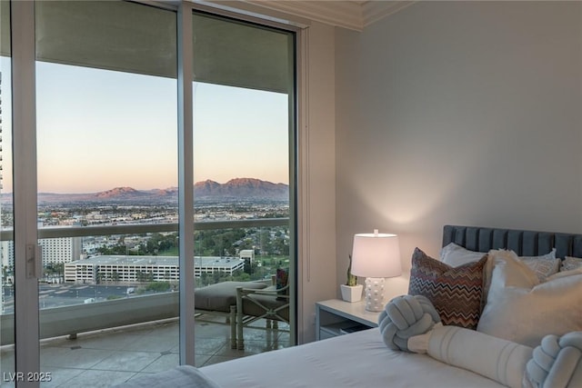 2877 Paradise Rd Unit 2502, Las Vegas, NV 89109 - bedroom featuring a mountain view, tile patterned flooring, and ornamental molding