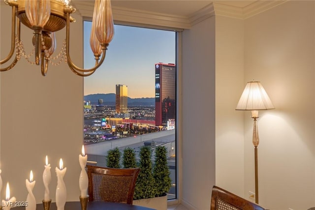2877 Paradise Rd Unit 2502, Las Vegas, NV 89109 - sitting room with a dry bar, ornamental molding, a chandelier, a city view, and baseboards