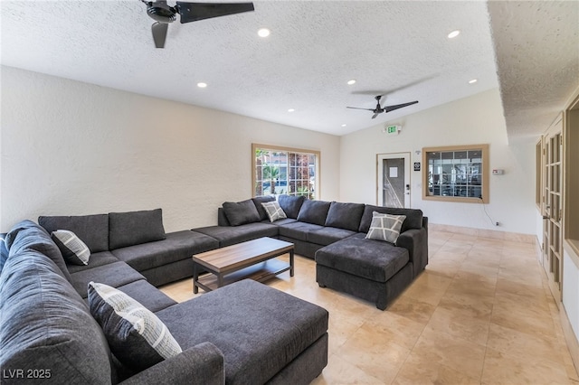 living area with lofted ceiling, a textured ceiling, a textured wall, recessed lighting, and a ceiling fan