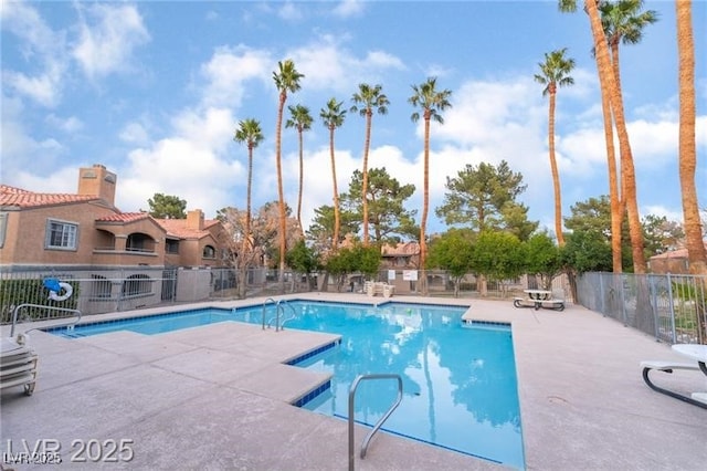pool featuring a patio and fence