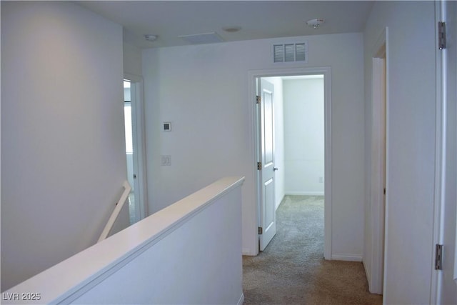 12186 Scarlet Ember Rd Unit 3, Las Vegas, NV 89183 - hallway featuring light colored carpet, baseboards, an upstairs landing, and visible vents
