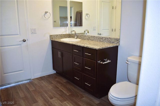 12186 Scarlet Ember Rd Unit 3, Las Vegas, NV 89183 - bathroom featuring toilet, vanity, and wood finished floors