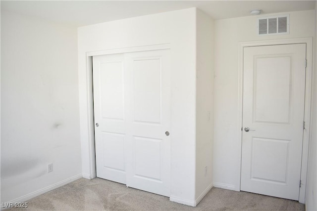 12186 Scarlet Ember Rd Unit 3, Las Vegas, NV 89183 - unfurnished bedroom featuring a closet, visible vents, baseboards, and light carpet