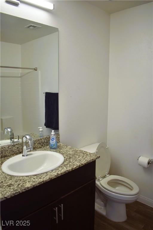 12186 Scarlet Ember Rd Unit 3, Las Vegas, NV 89183 - bathroom featuring wood finished floors, visible vents, toilet, vanity, and a shower