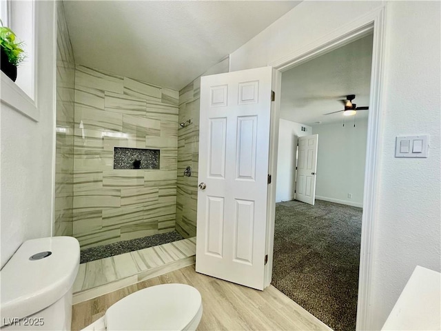 full bathroom with vaulted ceiling, walk in shower, toilet, and ceiling fan