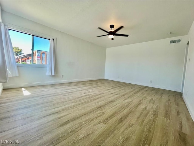unfurnished room featuring visible vents, baseboards, light wood finished floors, and a ceiling fan