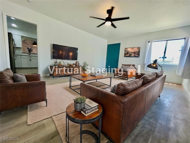 living area with ceiling fan and baseboards