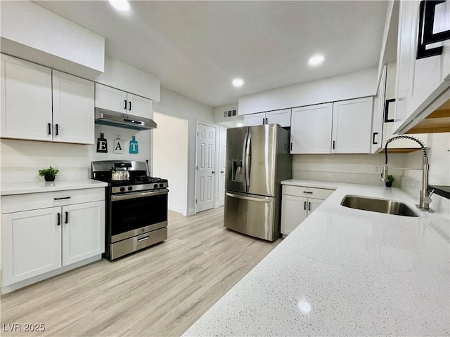 kitchen with recessed lighting, under cabinet range hood, visible vents, stainless steel appliances, and a sink